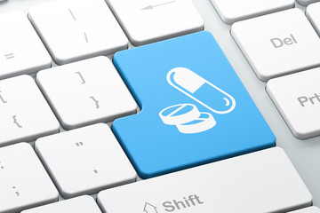 Healthcare concept: Pills on computer keyboard background