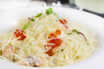 spaghetti with eggs decorated with greenery on a white background
