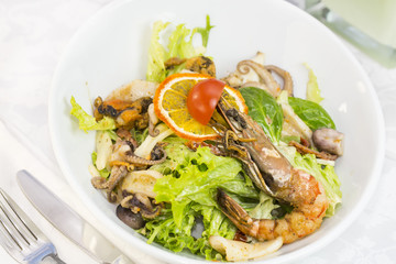 seafood salad on a plate on a white background