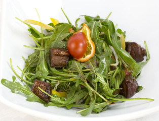 duck with arugula on a white background in the restaurant