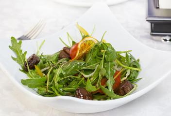 duck with arugula on a white background in the restaurant