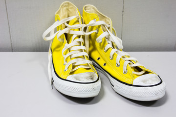 yellow shoes on a wooden floor