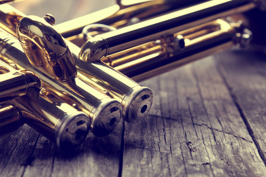 Trumpet on an old wooden table. Vintage style.