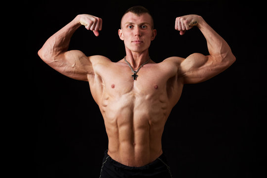 young bodybuilder showing double biceps