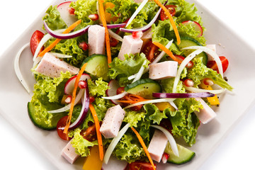 Ham and vegetables on white background