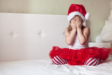 Children's feet in the New Year's striped pajama bottoms to bed,