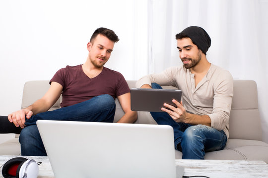 Two young men using a tablet pc