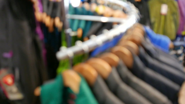  Tourist  outdoor clothes on angers. Panorama in  outdoor shop, blurred scene. 4K 3840x2160