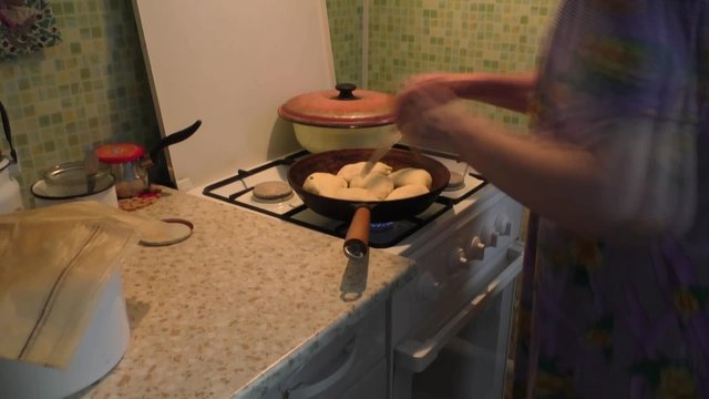 Women fry the patties in a frying pan