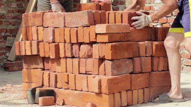 building bricks pile/on building up the brick pile pander to the hands