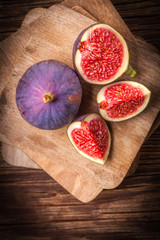 Sliced figs on a wooden table. Top view.