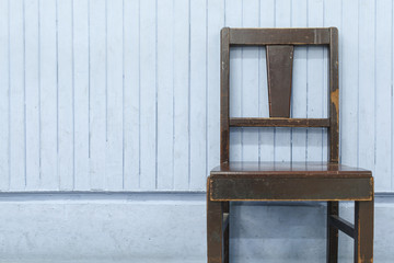 Old wooden chairs on blue wood wall