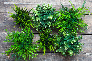 Fake grass in black pots on wooden desk