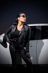 Naklejka premium Young woman in leather clothes