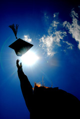 A graduate tosses a cap.