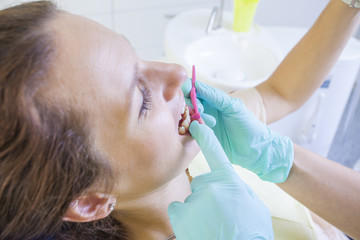 Female dentist working on teeth of woman in a dentist room