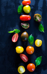 Multicolored cherry tomatoes and basil