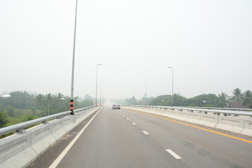 Fototapeta premium Smoke from forest fires in Indonesia blows across Phatthalung Thailand 