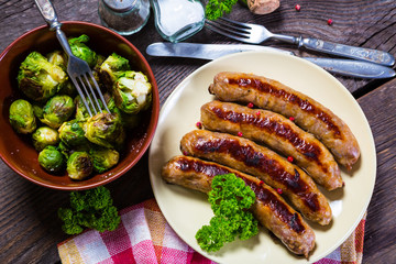 Fried sausages with parsley and brussels sprouts