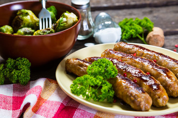 Fried sausages with parsley and brussels sprouts