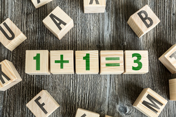 Wooden Blocks with the text: 1+1=3