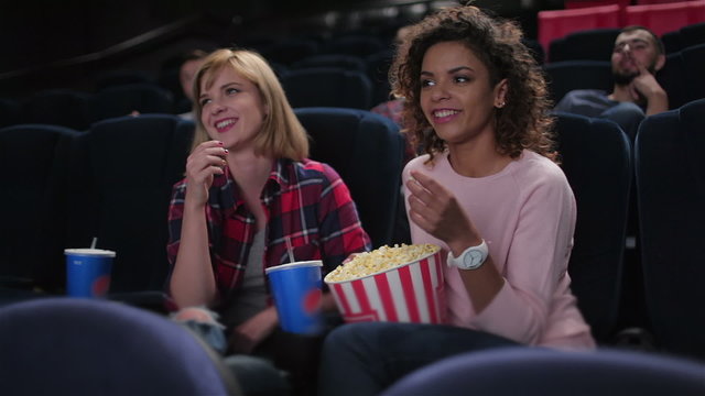 Group of smiling people watching movie