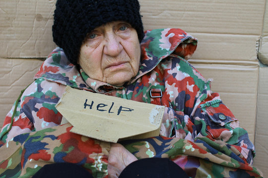 Homeless Women Sitting On A Street