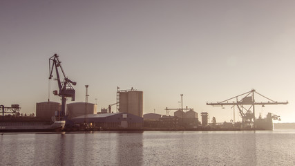 Fototapeta na wymiar Cranes unload cargo in a seaport in Sweden