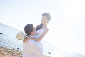 Just married happy couple on a sandy beach