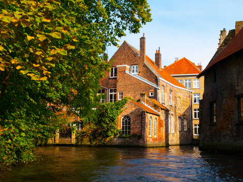 Medieval Houses Along Canals Of Bruges In Autumn Time