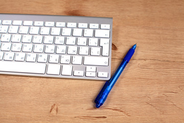 Modern aluminum computer keyboard on the table