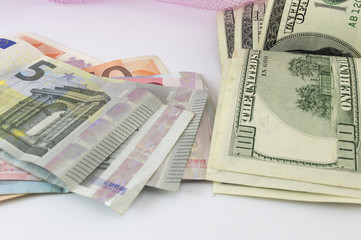 Stack of euro and dollar bills on a table