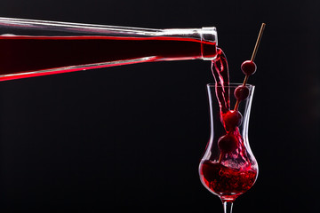cranberry liquor on black background