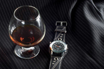 glass cognac and expensive watches