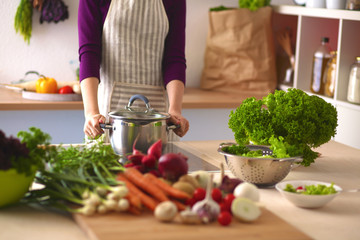 Young Woman Cooking in the kitchen. Healthy Food