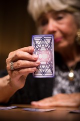 Tarot reader holding magic card