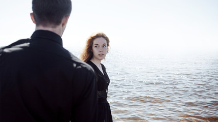 beautiful young couple hugging standing in the sea, photo