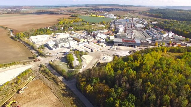 Camera flight over industrial zone with ceramics factory and kaolin quarry near Pilsen city in Czech Republic, Europe. 