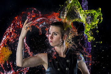 Modern Woman Being Splashed with Colorful Water