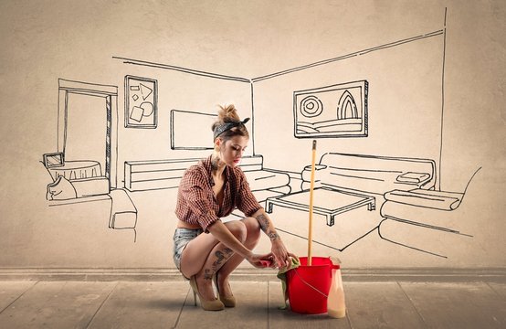 Woman cleaning a floor daydreaming of a cozy living room