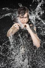 Woman in Boxing Stance Being Splashed with Water