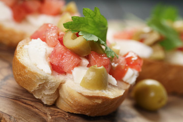 homemade crostini with tomato, mozzarella and olives
