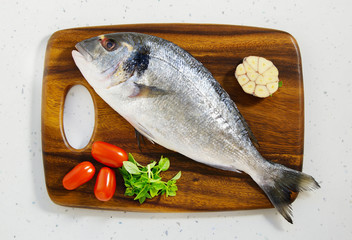 dorada fresh raw on the wooden board