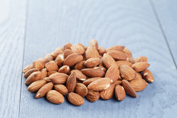 roasted almonds on blue wooden table