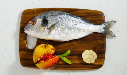 dorada fresh raw on the wooden board