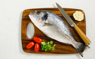 dorada fresh raw on the wooden board