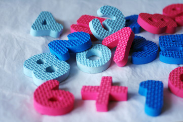 Bright multi-colored figures are scattered chaotically on a table