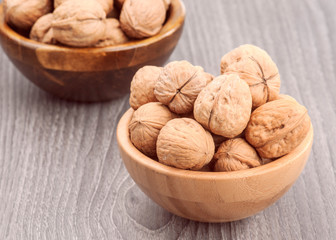 Walnuts on rustic wooden table