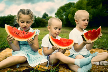 Children eating watermelon outdoor