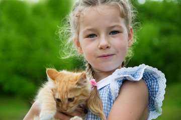 Lovely girl with a kitten in her arms